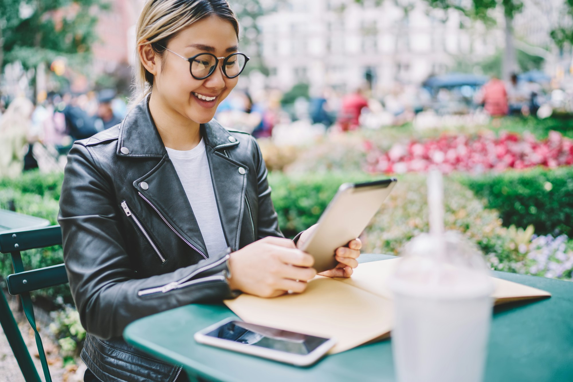 Happy Chinese student searching media content and smiling